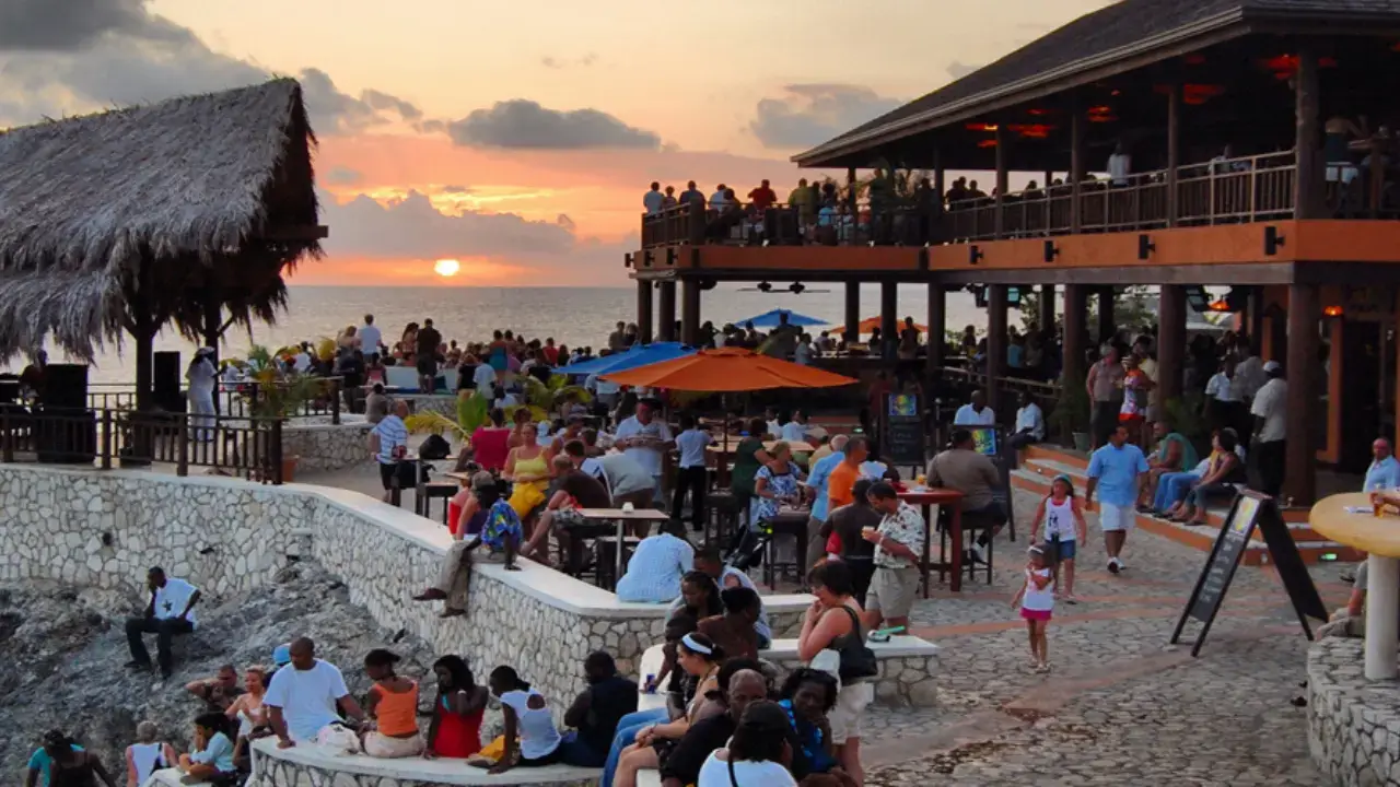 People enjoying sunset view at rick's cafe Jamaica