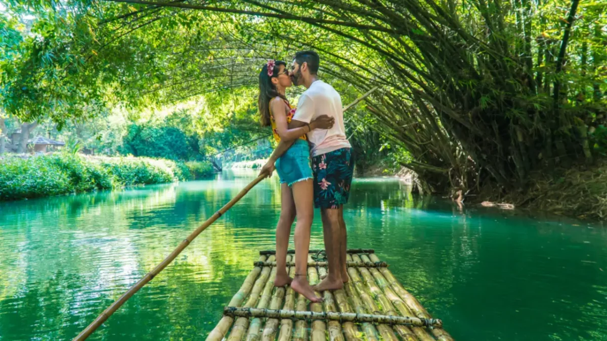 A couple enjoying the Bamboo rafting experience at great river , Jamaica